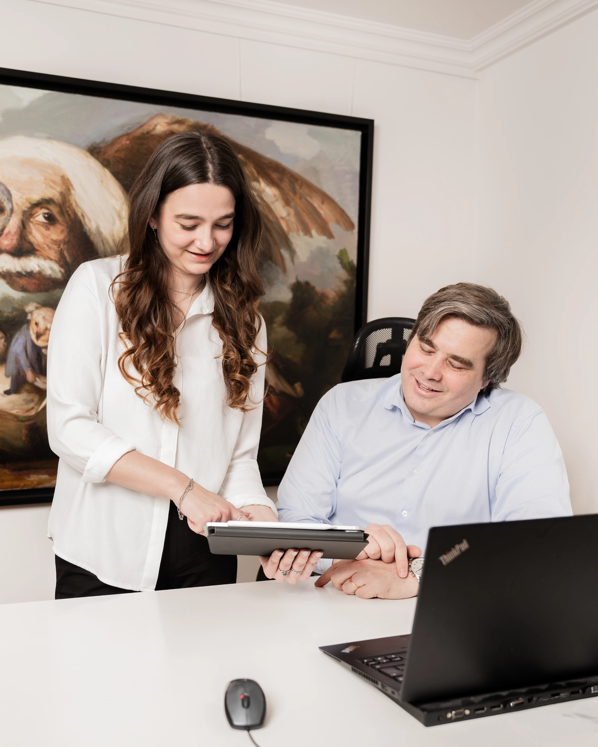 Dr. Sebastian Kraska speaking with a colleague at work